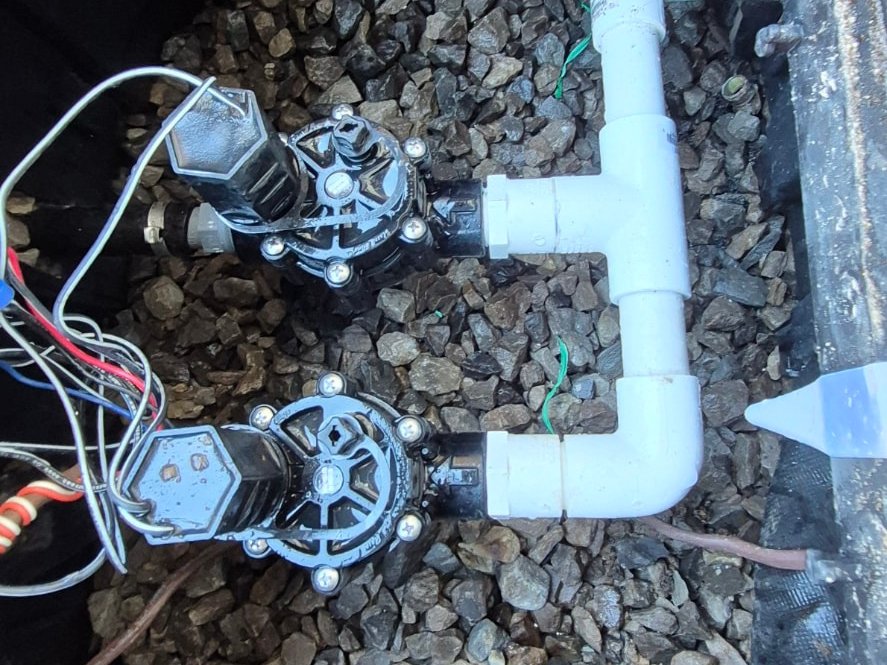Two irrigation zone valves on a new PVC manifold in a valve box – HigreenWall Irrigation